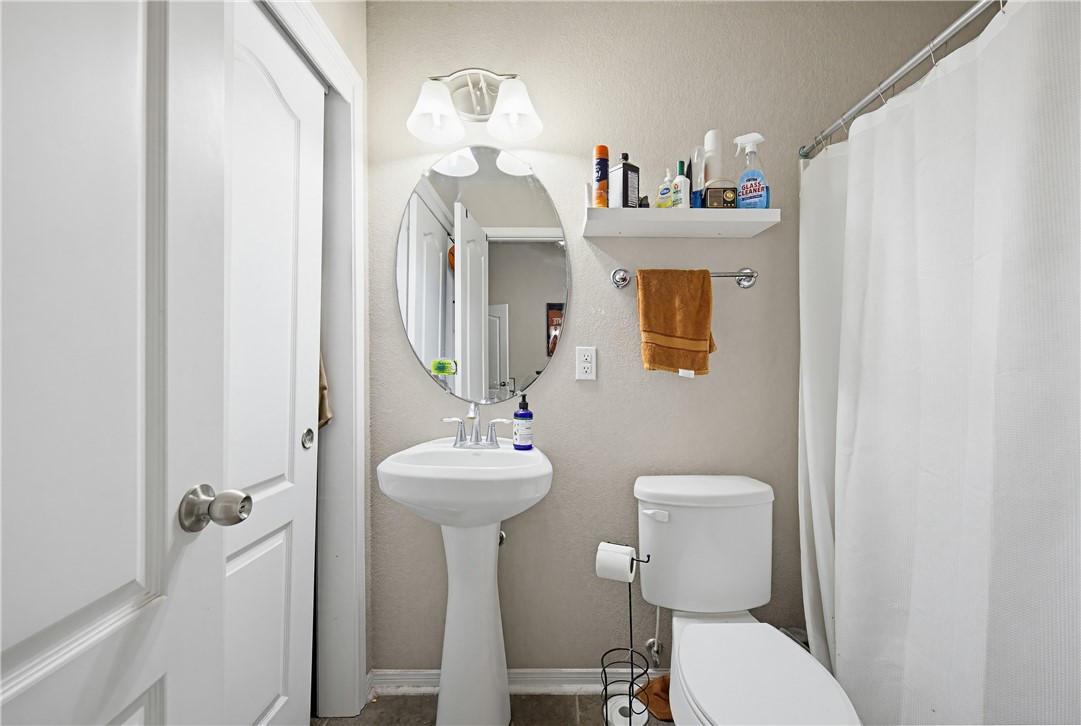 2129 Escondido Street Portland, TX 78374 - Photo 24 of 29 a bathroom with a toilet sink and mirror