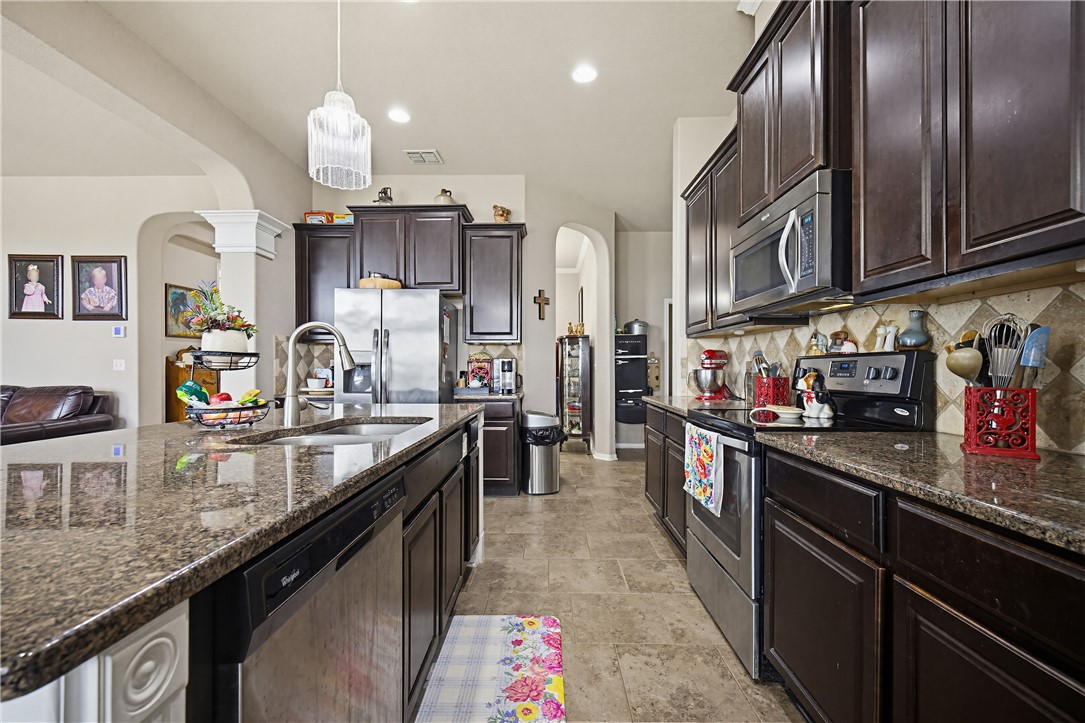 2129 Escondido Street Portland, TX 78374 - Photo 7 of 29 a kitchen with stainless steel appliances granite countertop a sink stove and refrigerator