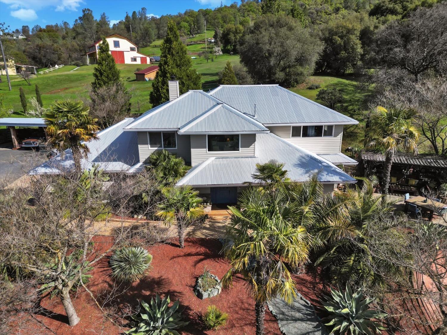 a front view of a house with a yard and fountain