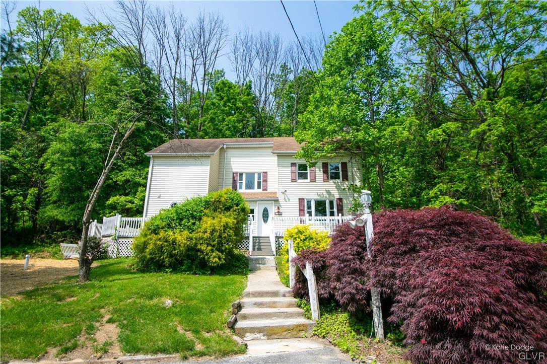 395 Buttermilk Road Easton, PA 18042 - Photo 1 of 41 a front view of a house with a garden and plants