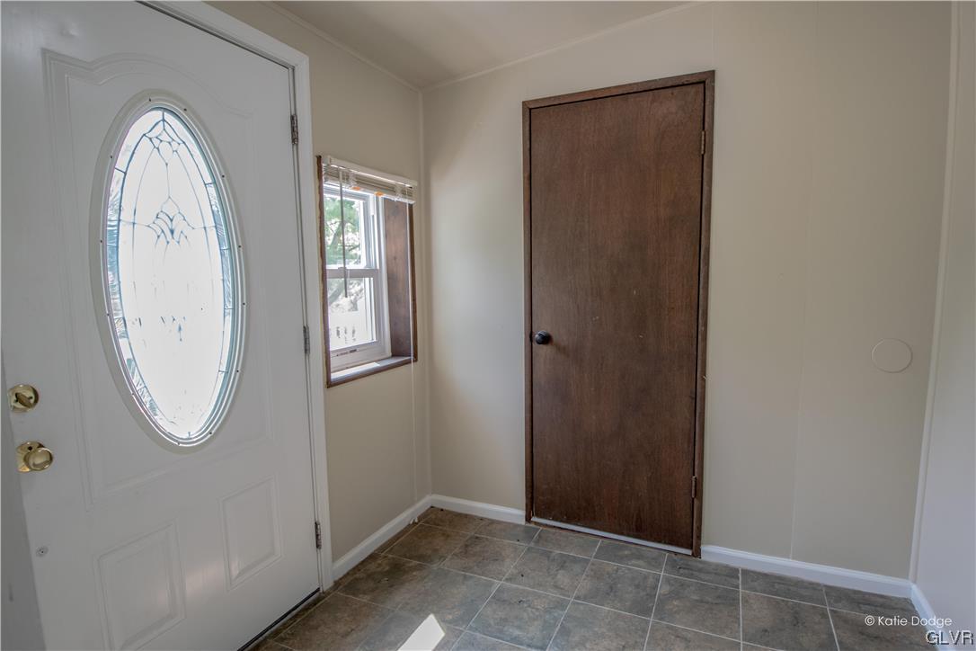 395 Buttermilk Road Easton, PA 18042 - Photo 2 of 41 an empty room with mirror window and glass door