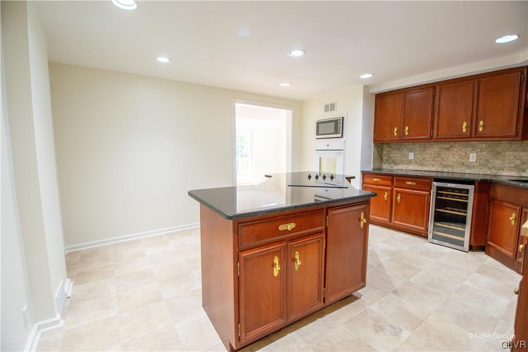 395 Buttermilk Road Easton, PA 18042 - Photo 6 of 41 a kitchen with stainless steel appliances granite countertop a sink stove and cabinets