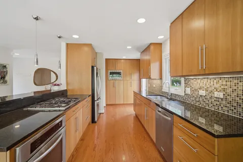a kitchen with stainless steel appliances granite countertop a stove and a sink