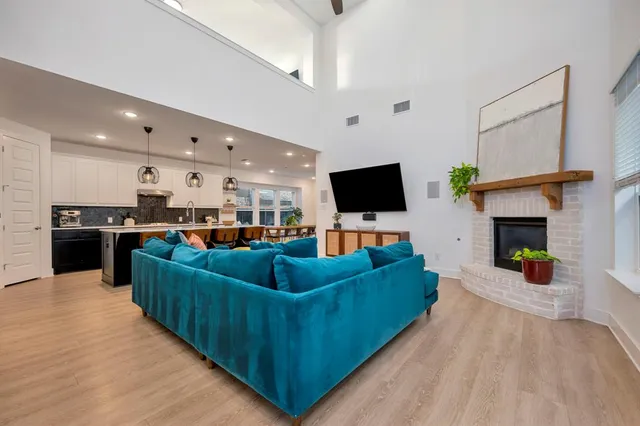 a living room with furniture and kitchen view