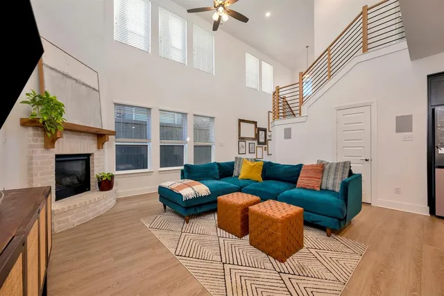 a kitchen with stainless steel appliances granite countertop a sink a stove and a wooden floors