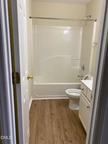a bathroom with a shower a toilet and a shower