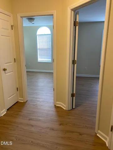 a view of hallway with wooden floor