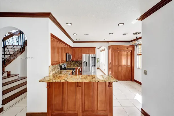 a view of a kitchen with furniture and staircase