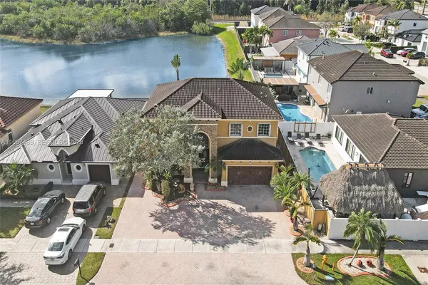 an aerial view of a house with garden space and lake view