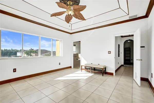 a living room with a large window and furniture
