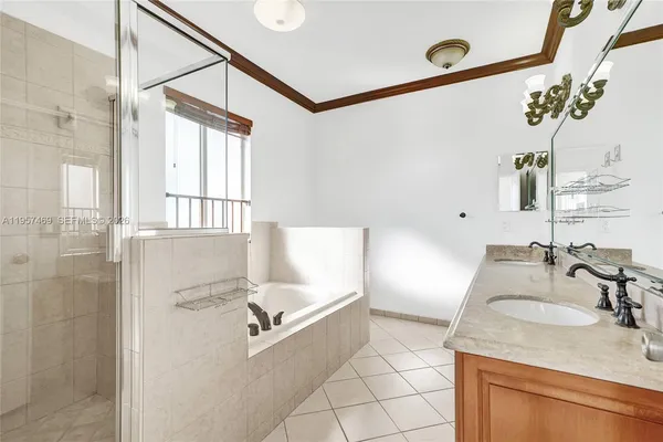 a bathroom with a granite countertop sink a mirror and shower