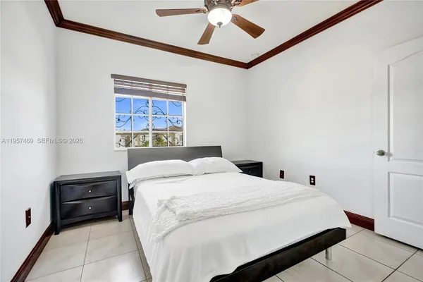 a bedroom with a bed and a ceiling fan