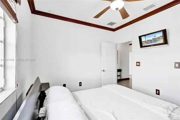 a bedroom with a bed and a large mirror