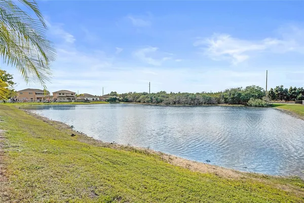a view of a lake with houses in the background