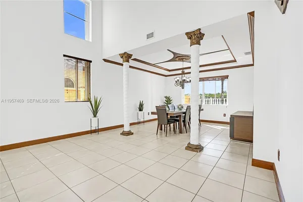 a view of dining room and kitchen with table and chairs