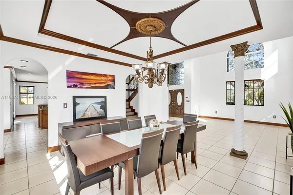 a view of a dining room with furniture and a chandelier
