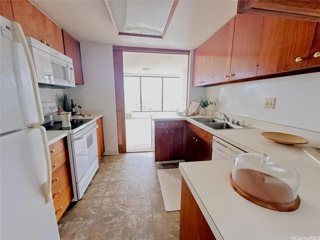 a white toilet sitting next to a shower