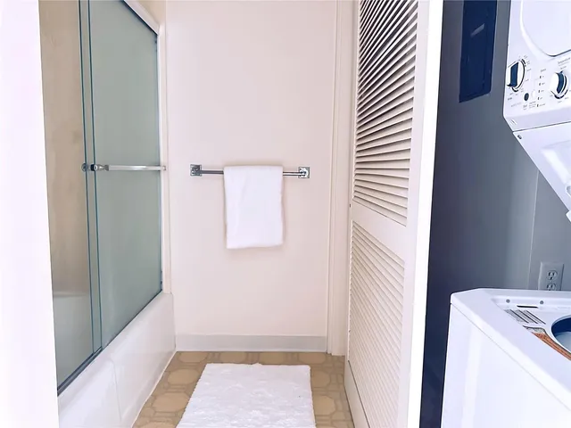 a view of a house with a small yard and wooden fence