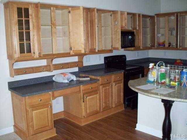 844 Horton Road, Unit 24 Durham, NC 27704 - Photo 3 of 3 a kitchen with stainless steel appliances granite countertop a sink a stove and a microwave