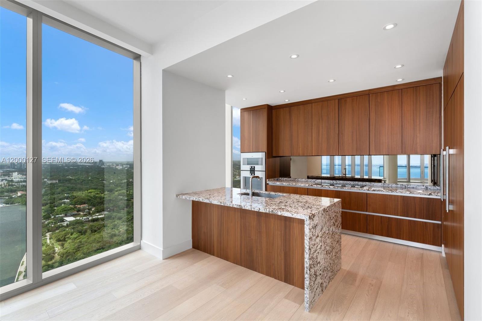 175 Southeast 25th Road, Unit 3602 Miami, FL 33129 - Photo 20 of 25 a kitchen with stainless steel appliances granite countertop wooden cabinets a counter top and a sink