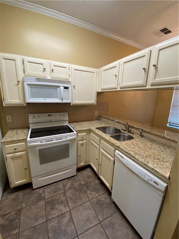 2802 Nueces Street, Unit 311 Austin, TX 78705 - Photo 1 of 13 a kitchen with a stove and white cabinets