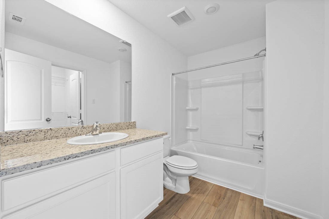 109 McLintock Road Jarrell, TX 76537 - Photo 8 of 8 Full bath off guest room includes granite counters, designer white cabinetry and luxury vinyl plank flooring.