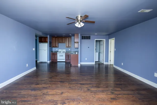 an empty room with windows and closet