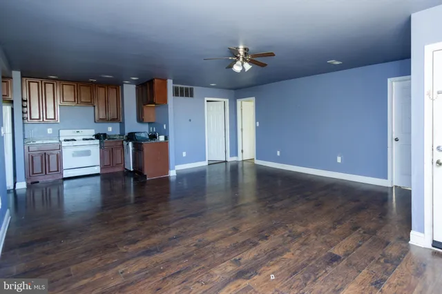 a view of a kitchen with wooden floor and a kitchen