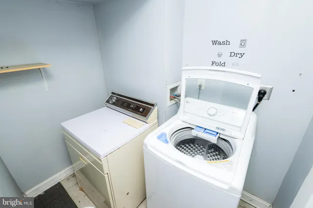 a view of a kitchen with a sink and a refrigerator