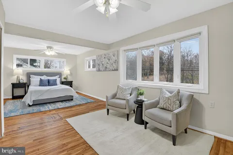 a bedroom with furniture and a large window