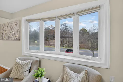 a living room filled with furniture and a window