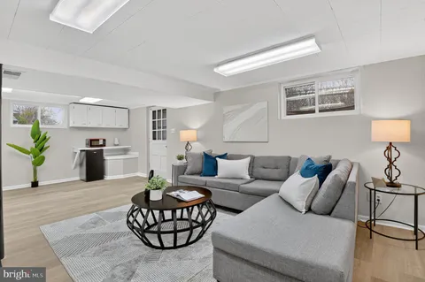 a living room with furniture and kitchen view