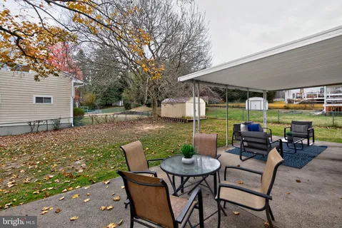 a view of a patio with a table and chairs