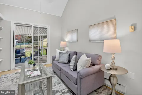 a living room with furniture and a lamp