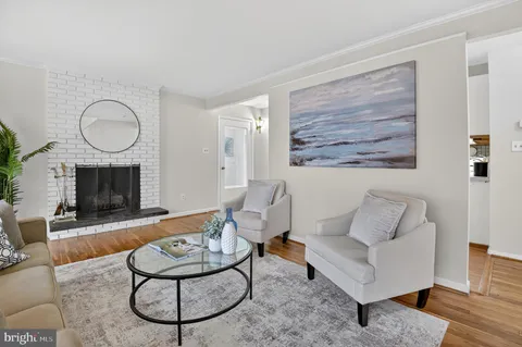 a living room with furniture a rug and a fireplace