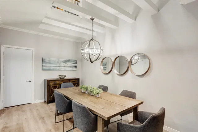 a kitchen with stainless steel appliances kitchen island granite countertop a refrigerator a stove a microwave oven a sink with a dining table and chairs