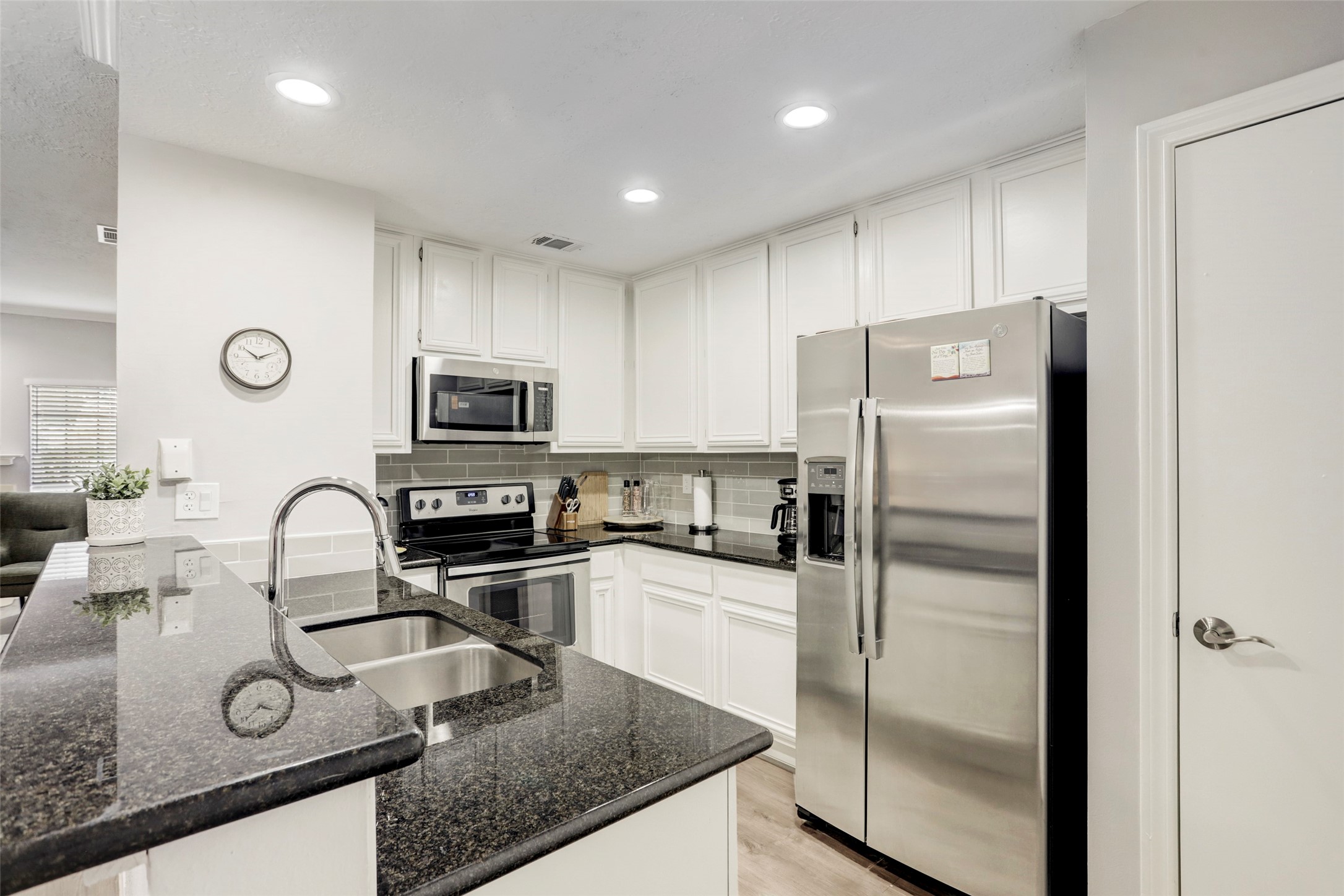 1911 Bering Drive, Unit 34 Houston, TX 77057 - Photo 14 of 26 a kitchen with granite countertop a refrigerator and a stove top oven
