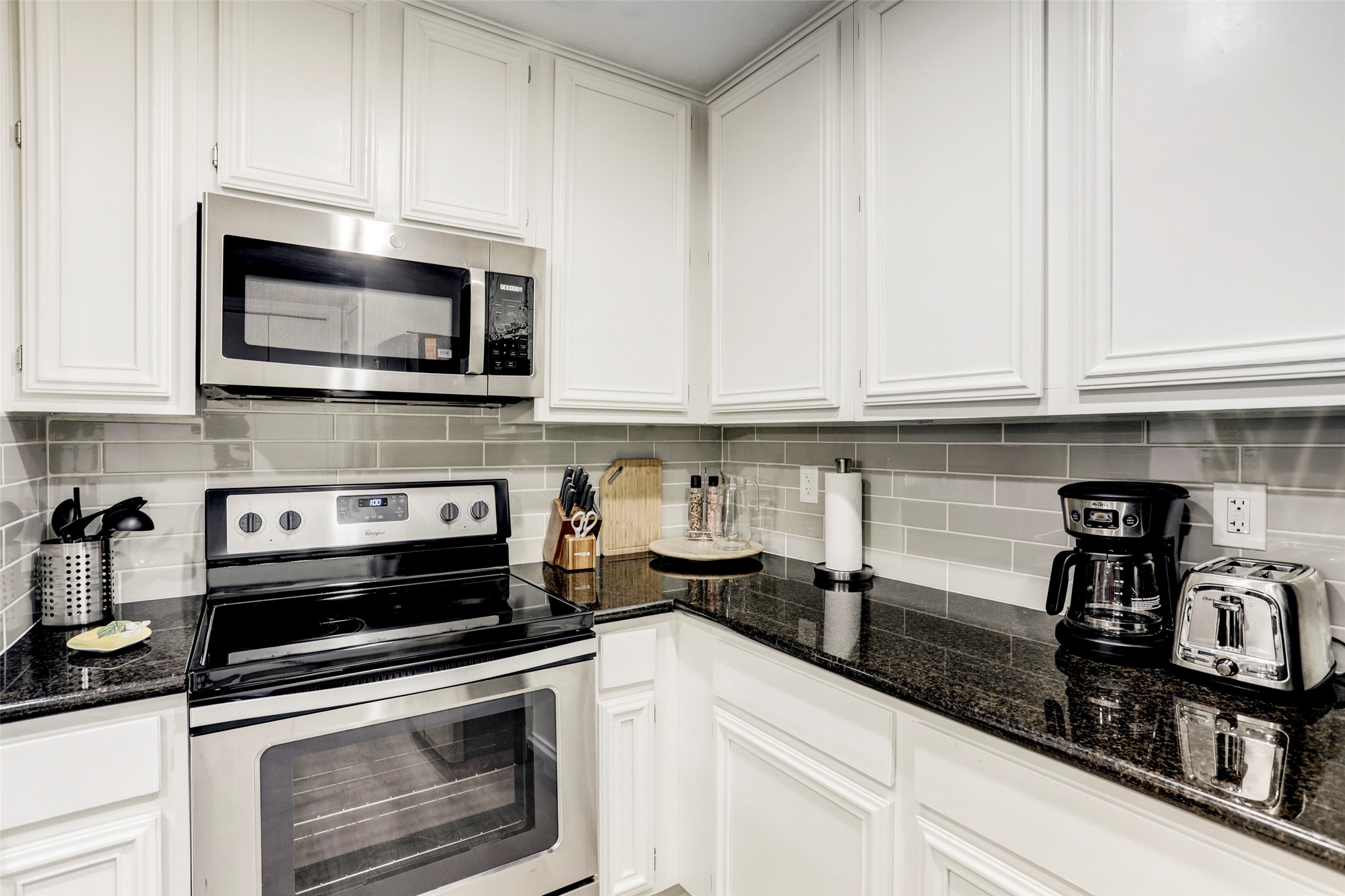 1911 Bering Drive, Unit 34 Houston, TX 77057 - Photo 15 of 26 a kitchen with granite countertop a stove and a microwave