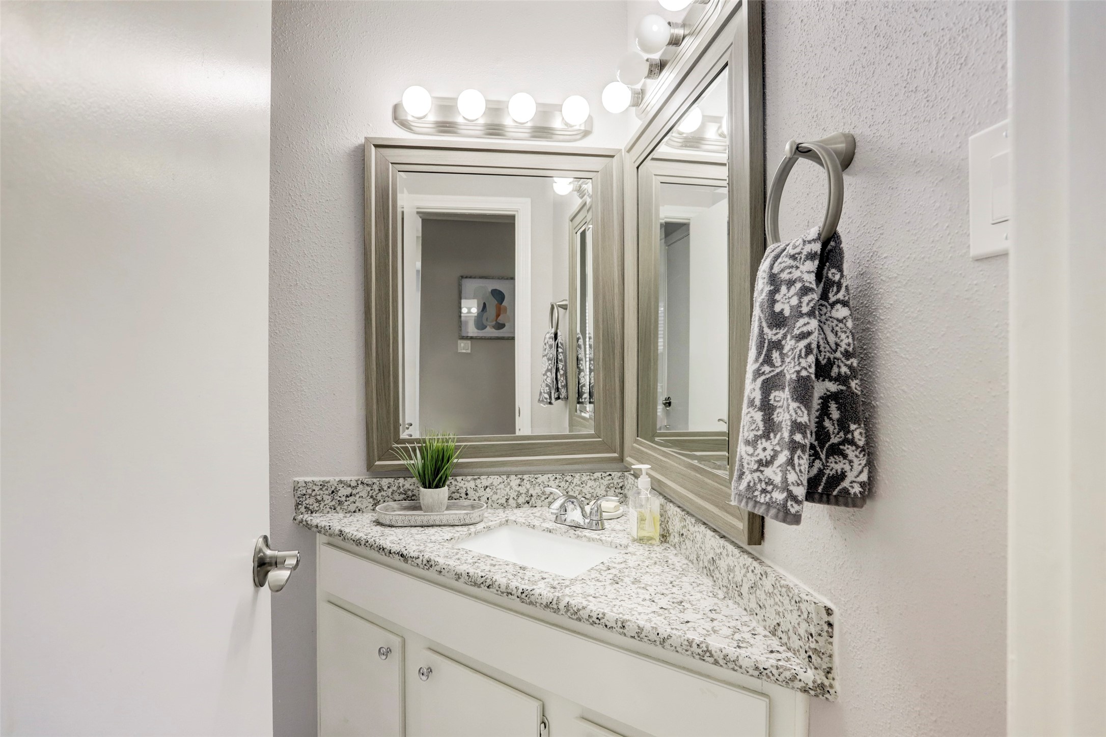1911 Bering Drive, Unit 34 Houston, TX 77057 - Photo 18 of 26 a bathroom with a granite countertop sink a mirror and a shower