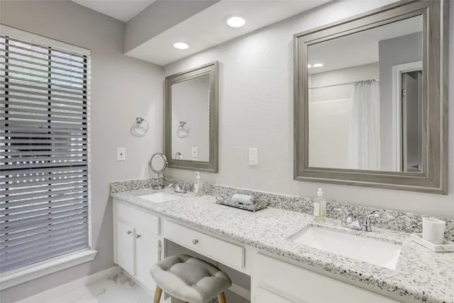 a living room with furniture and a book shelf