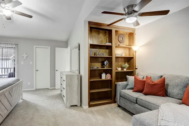 a bedroom with a bed chandelier and a window