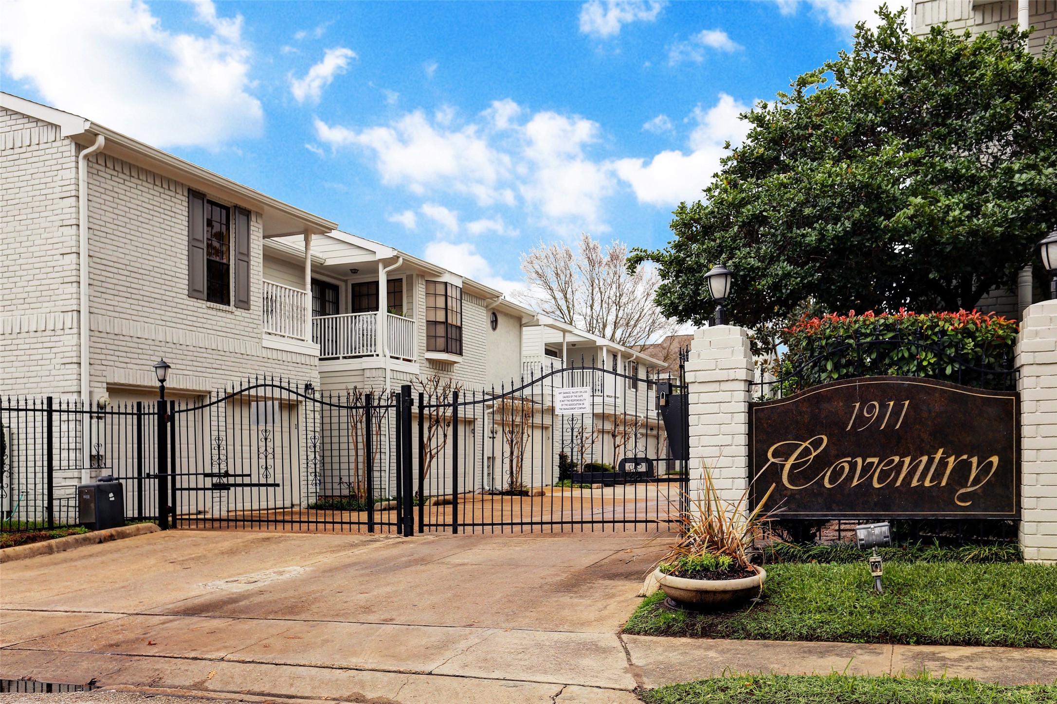 1911 Bering Drive, Unit 34 Houston, TX 77057 - Photo 3 of 26 a front view of a building with street sign