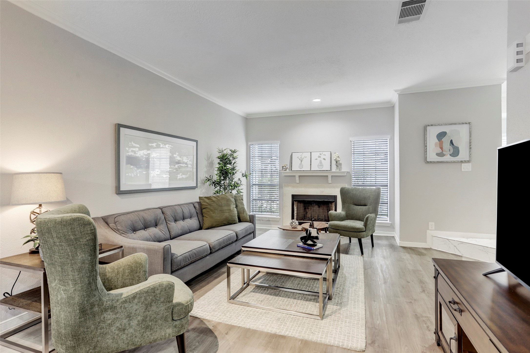 1911 Bering Drive, Unit 34 Houston, TX 77057 - Photo 6 of 26 a living room with furniture a fireplace and a flat screen tv