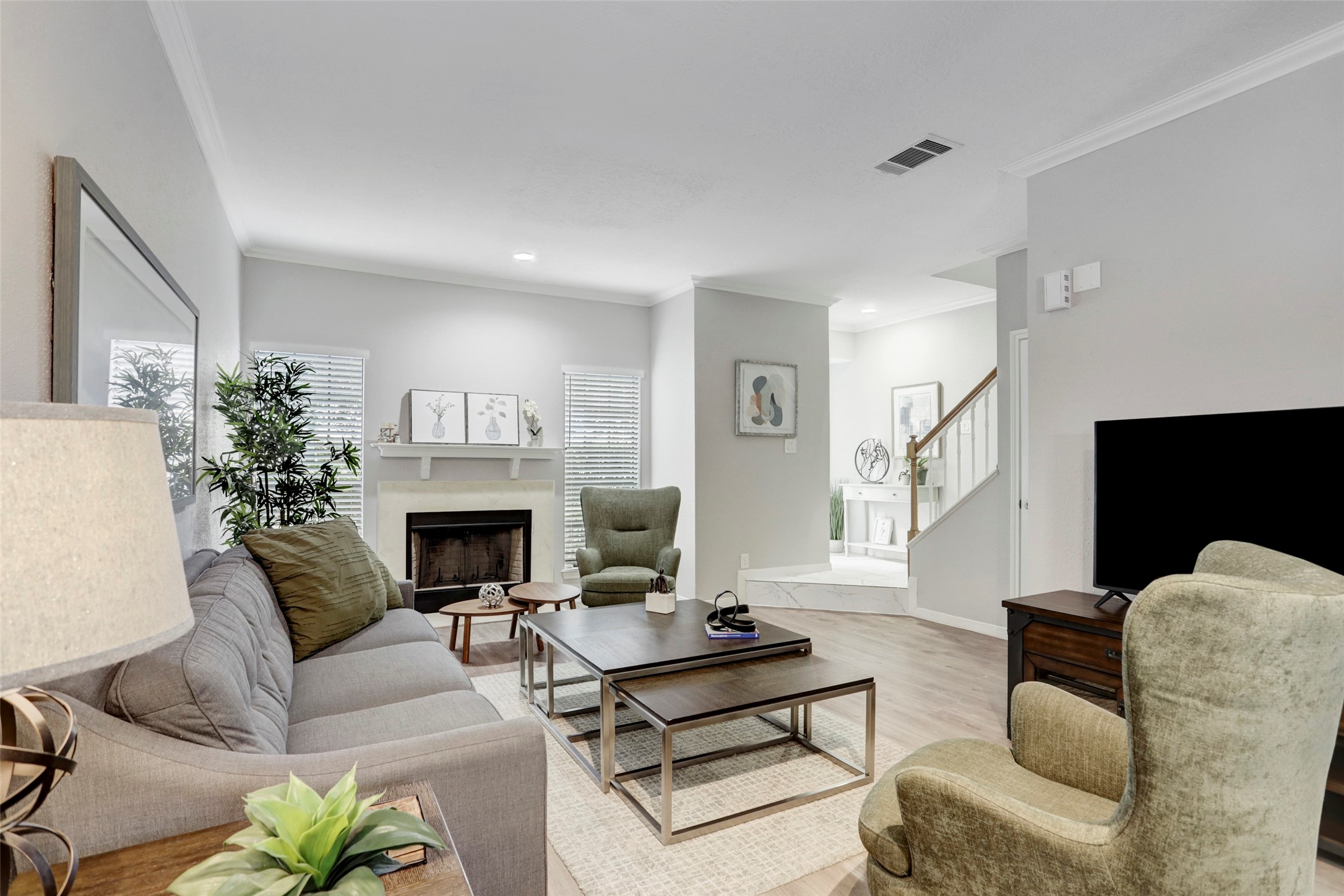 1911 Bering Drive, Unit 34 Houston, TX 77057 - Photo 7 of 26 a living room with furniture a fireplace and a potted plant