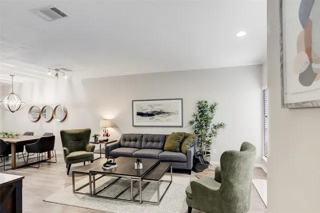a living room with furniture fireplace and window