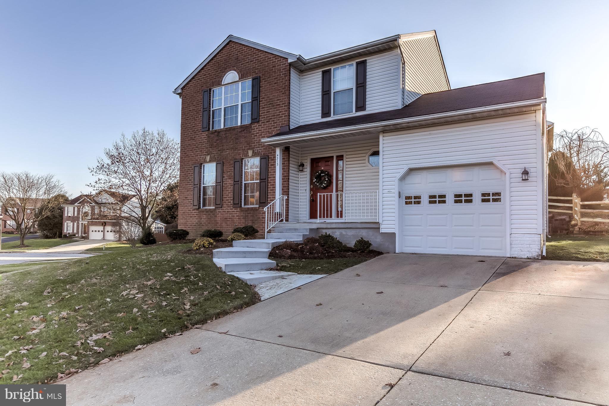 4313 Mispillion Road Baltimore, MD 21236 - Photo 2 of 38 a front view of a house with a yard and garage