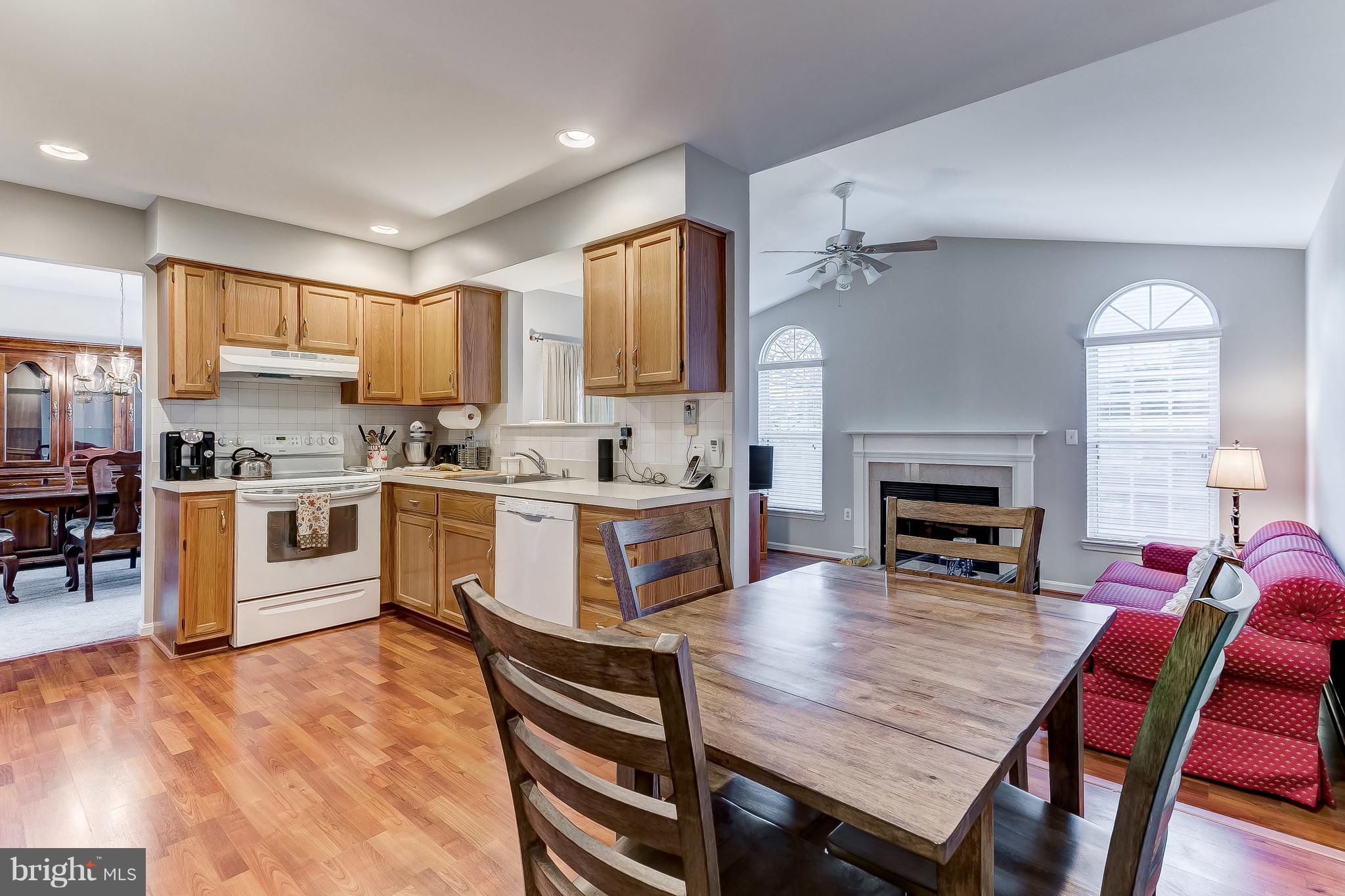 4313 Mispillion Road Baltimore, MD 21236 - Photo 10 of 38 a kitchen with a table chairs sink stove and cabinets