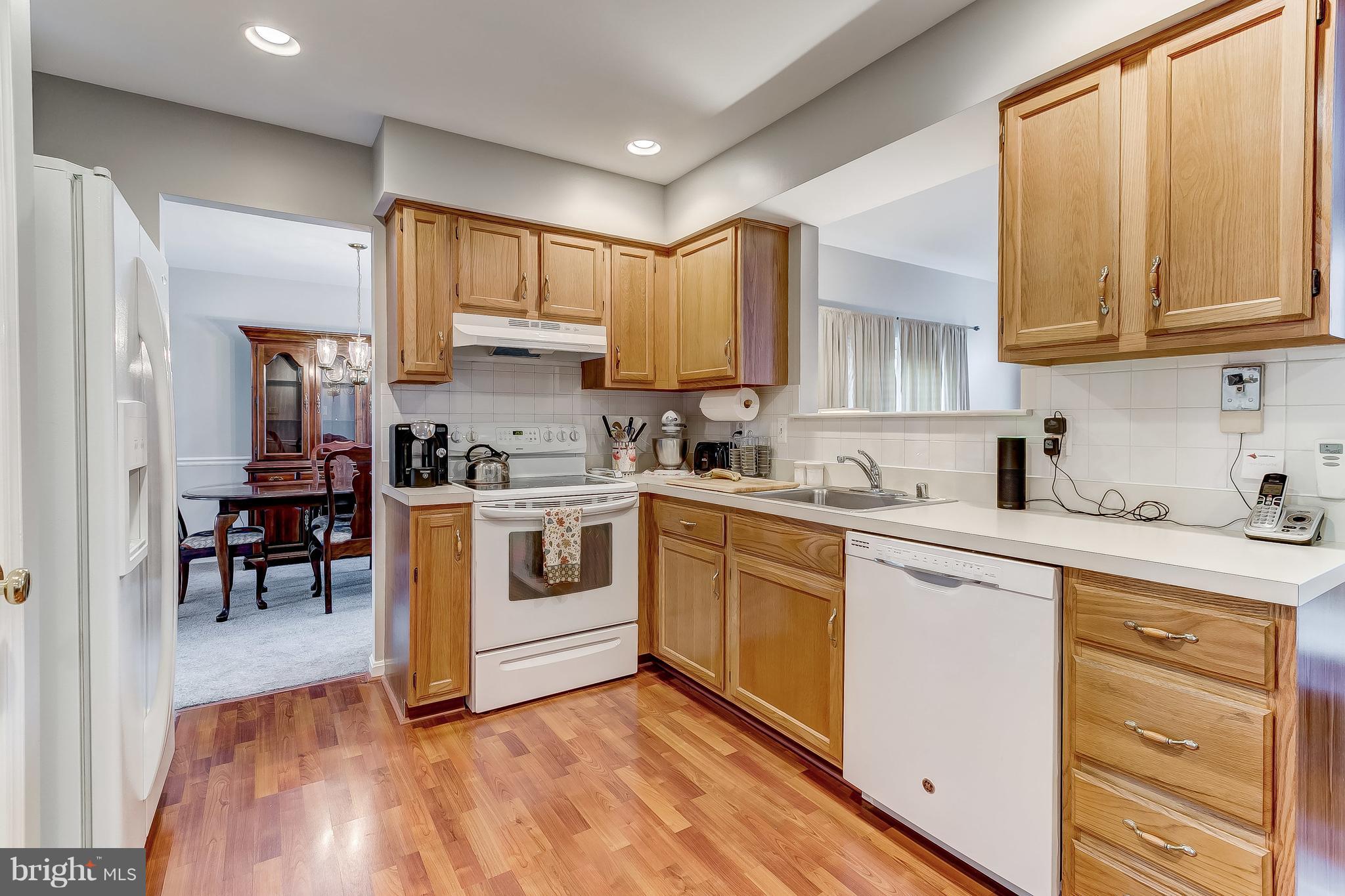 4313 Mispillion Road Baltimore, MD 21236 - Photo 11 of 38 a kitchen with stainless steel appliances granite countertop a stove a sink dishwasher and a refrigerator with wooden floor