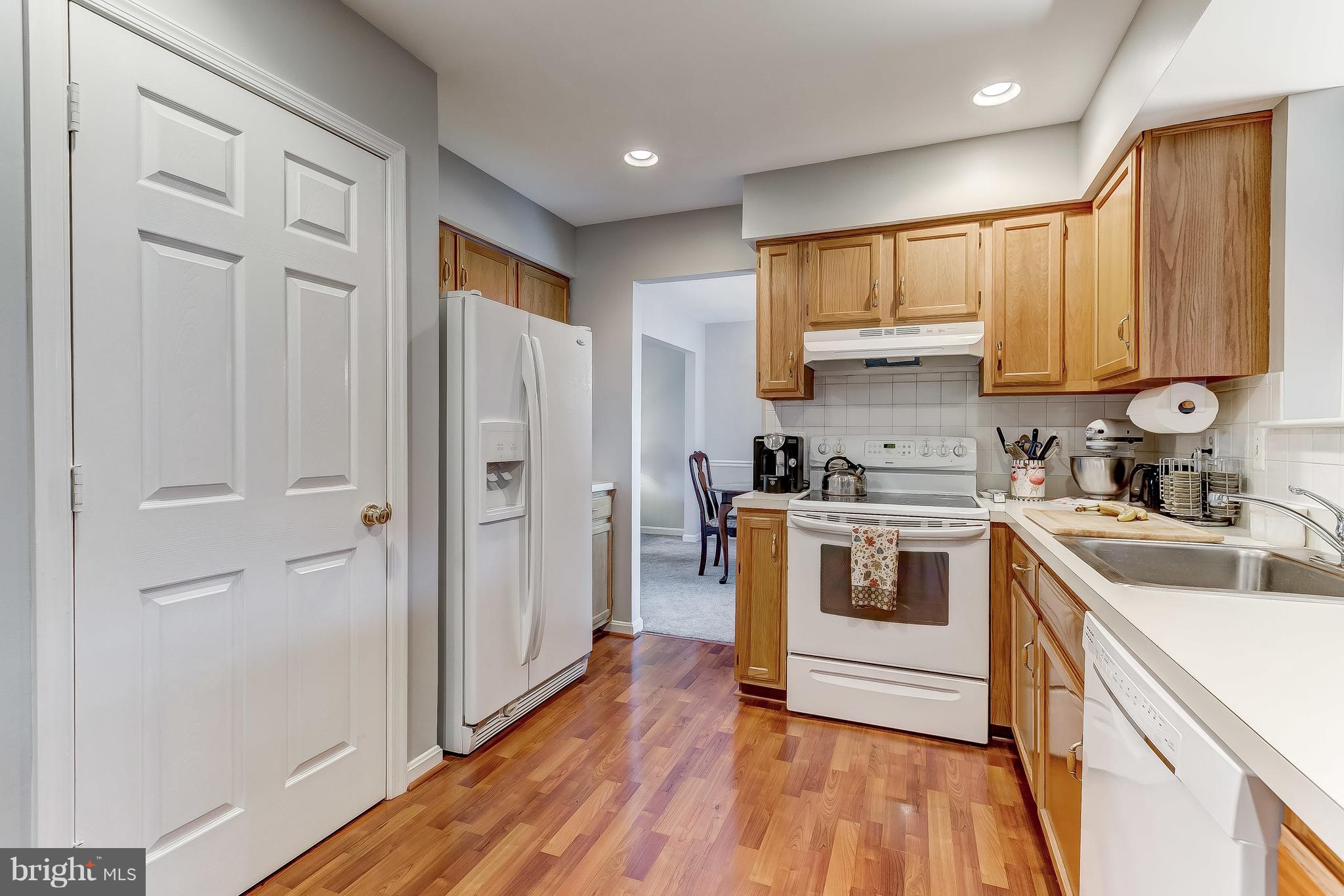4313 Mispillion Road Baltimore, MD 21236 - Photo 12 of 38 a kitchen with a refrigerator sink and cabinets