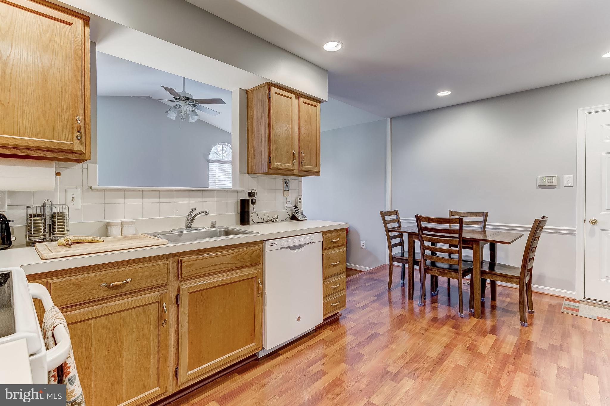 4313 Mispillion Road Baltimore, MD 21236 - Photo 13 of 38 a kitchen with sink cabinets and wooden floor
